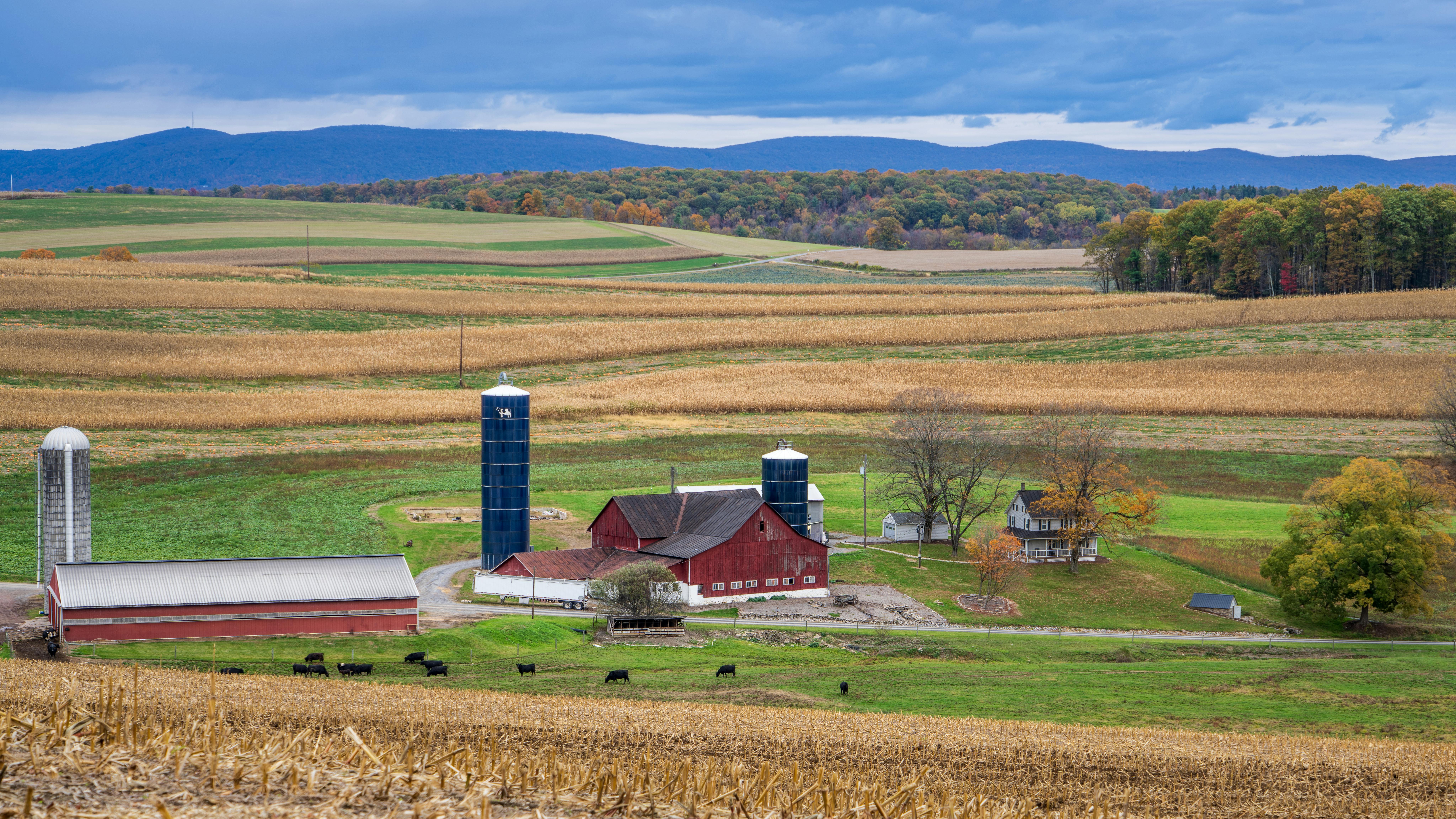 A modern farm with a red barn.