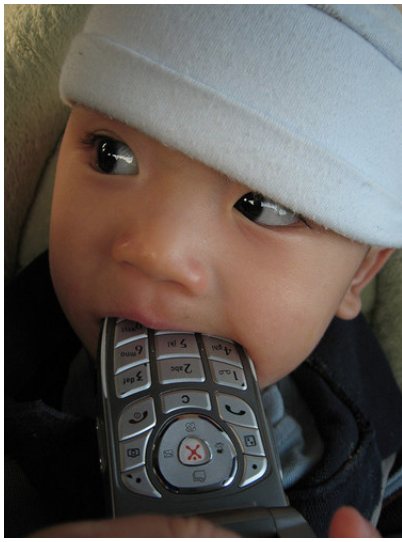 child biting a remote