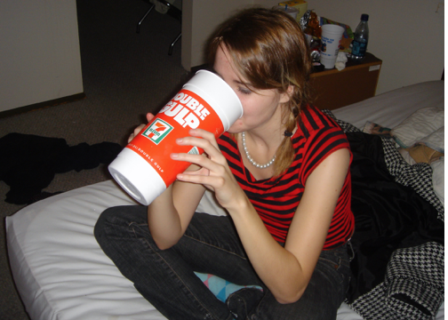 girl drinking from a big cup