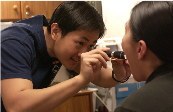 Capt. Wan Mun Chin examines a patient suffering from a sore throat