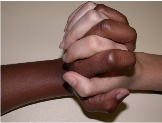 Diversity and Unity two people holding hands with different skin color