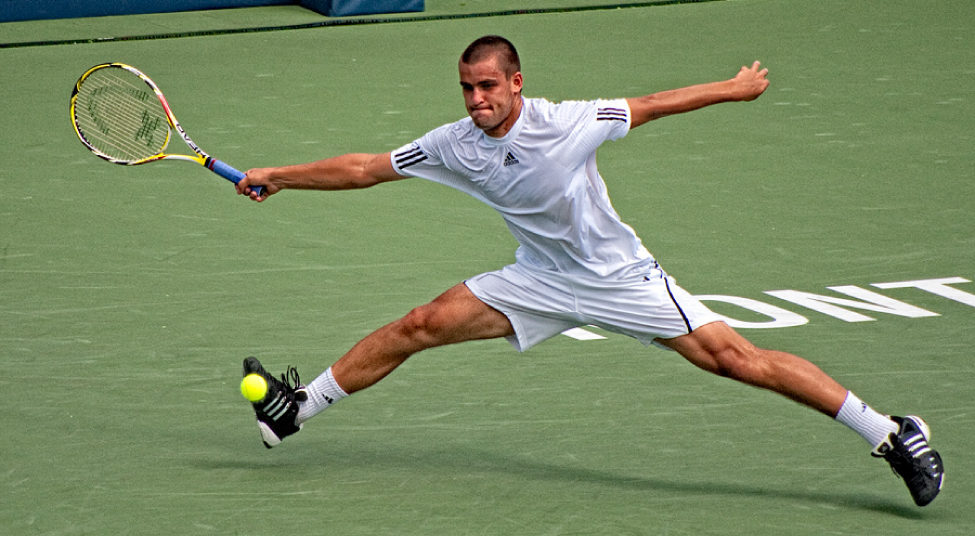 This photograph shows a man playing tennis.