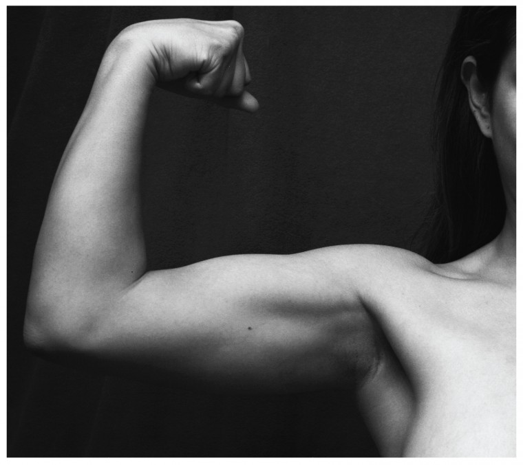 This photo shows a person flexing her biceps.