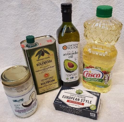 A photograph of various containers of oil and a package of butter.