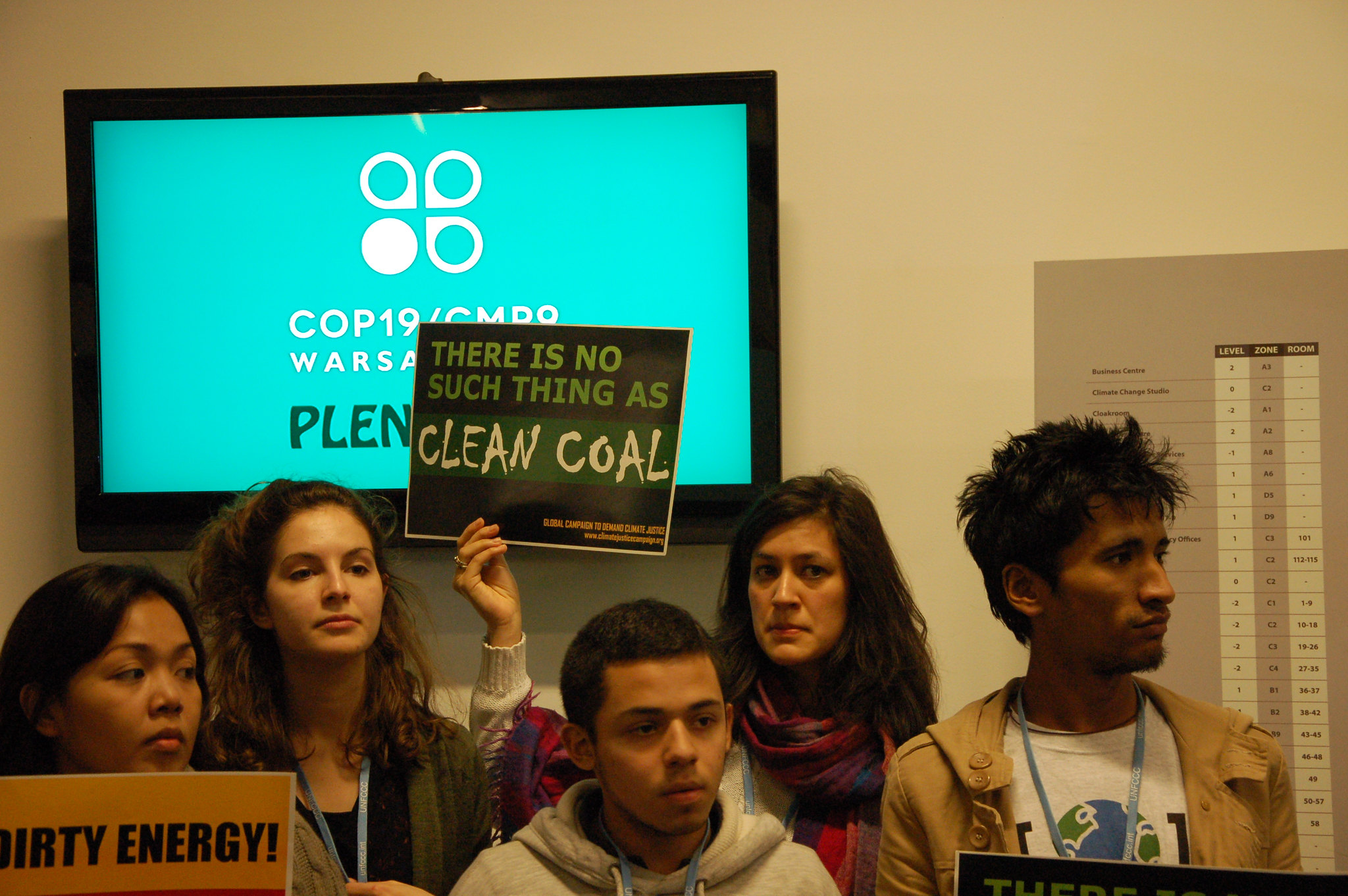 A group of young people hold a sign that says, "No coal is clean coal".