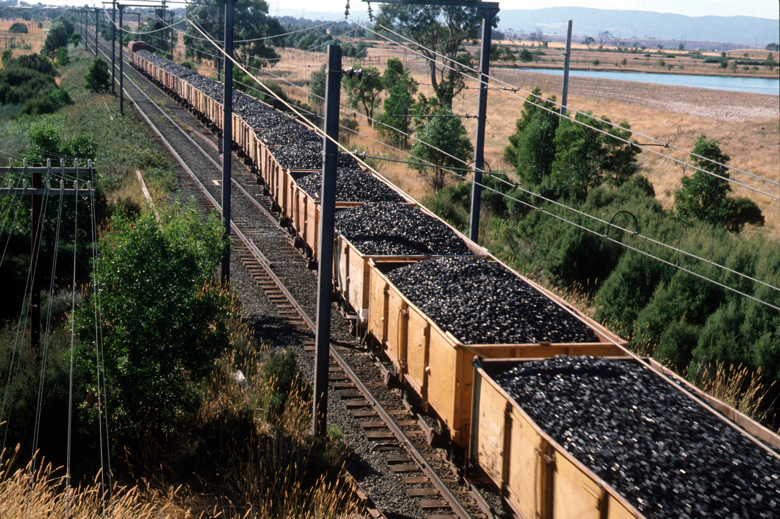 Cars of a train filled with coal in the form of black chunks