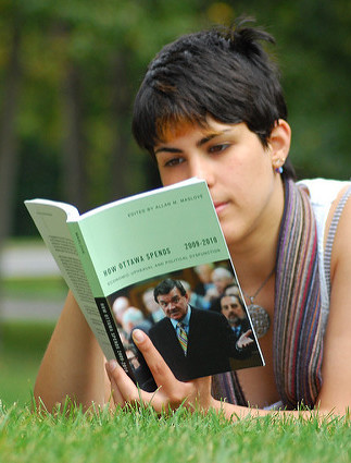A young woman reading a textbook.