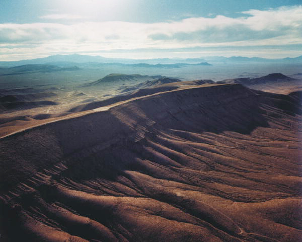 A barren landscape with a long mountain