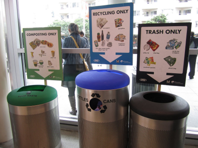A compost, recycling, and trash bin