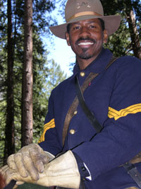 A photograph of Yosemite National Park ranger Shelton Johnson in the uniform of a "Buffalo Soldier" as part of a living history re-enactment.
