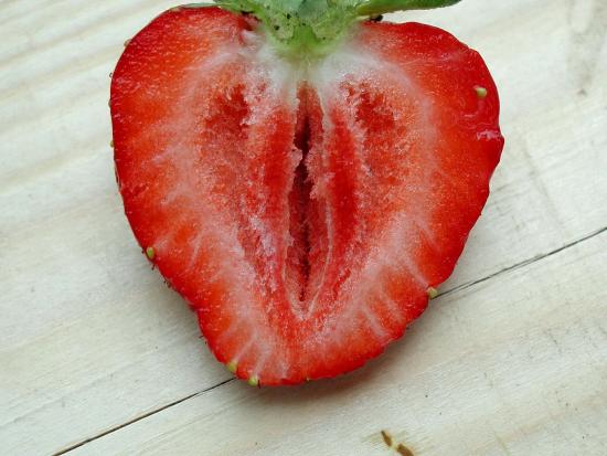 A strawberry, sliced longitudinally