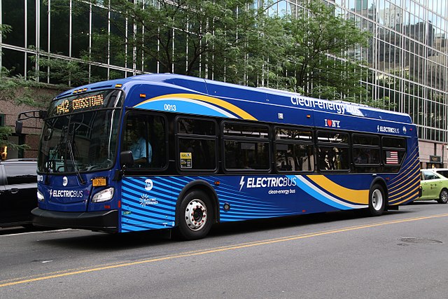 A blue electric bus that advertises its clean energy