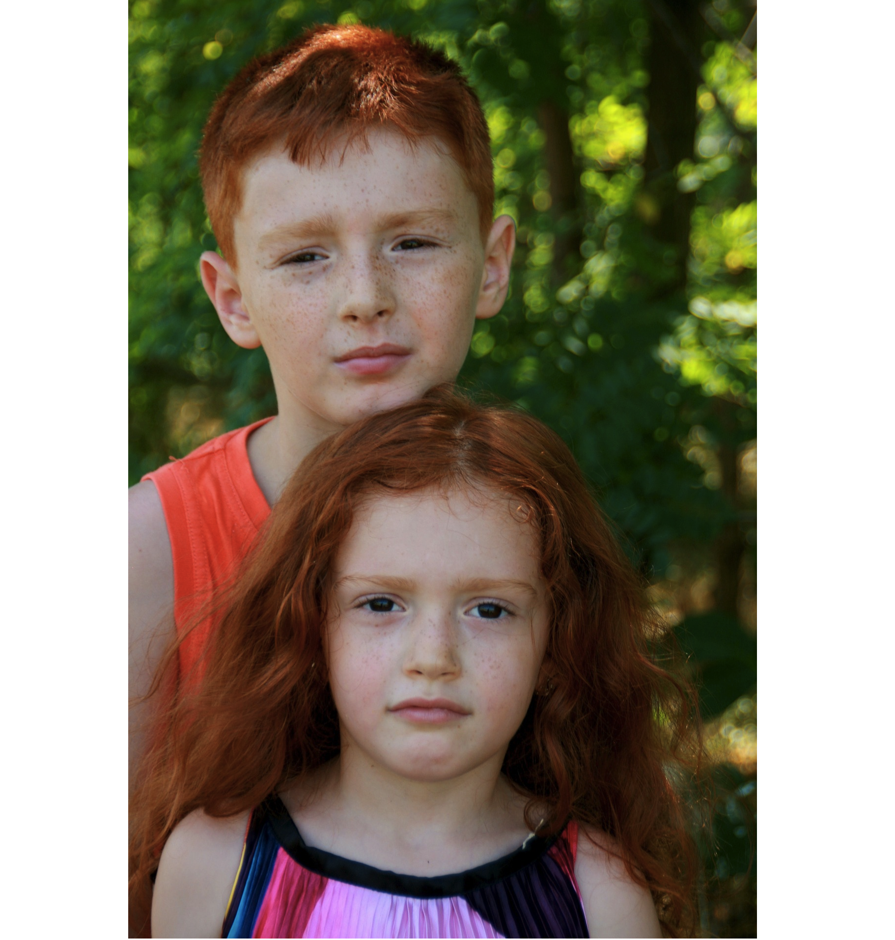 Image of a brother and sister who both have distinctive reddish hair.