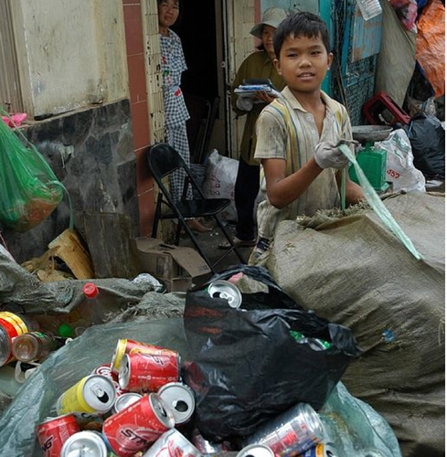 A young boy recycling garbage in Saigon.