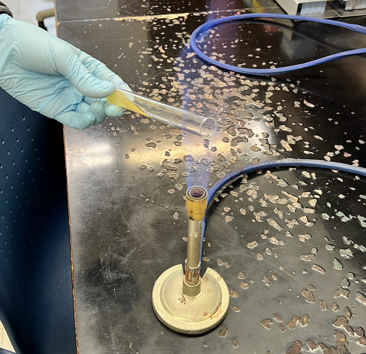 flaming the lip of a culture tube before or after aseptic transfer