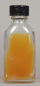 Photograph of an uninoculated flask of Dermatophyte Test Medium (DTM) showing its acidic pH (phenol red is yellow).