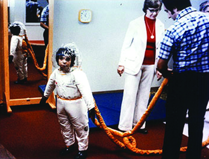 Photo of a boy in a suit similar to a space suit.